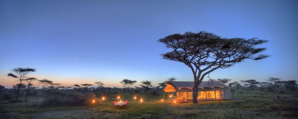 Guest tent and deck at a luxury camp under canvas in the Serengeti